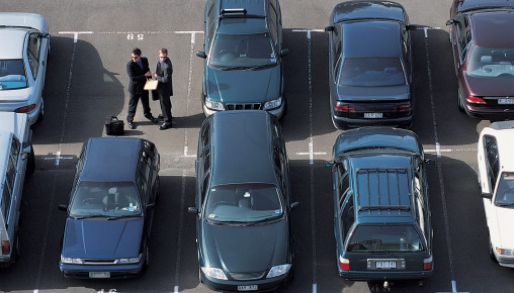 Shady individuals exchange money in a parking lot