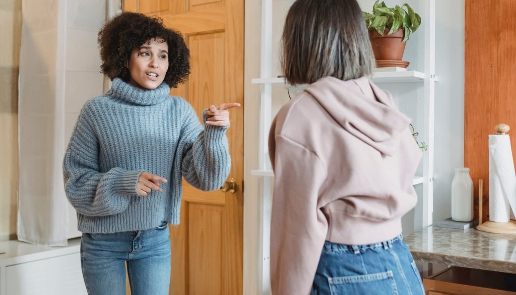 annoyed woman having conflict with anonymous female